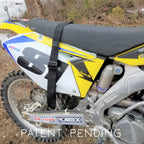 Close-up of a dirt bike with visible branding and 'Patent Pending' text on a natural background.